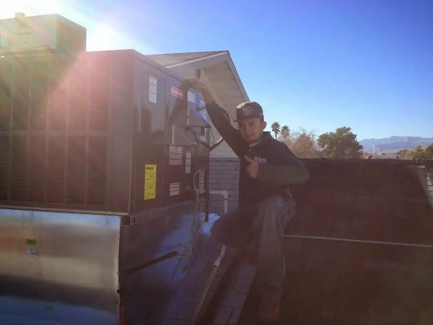 HVAC technician performing HVAC Inspection on a rooftop unit in The Colony